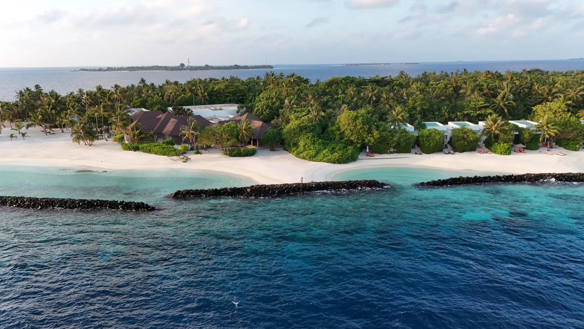 Aerial view of Niva Dhigali Maldives island, beach and tropical vegetation