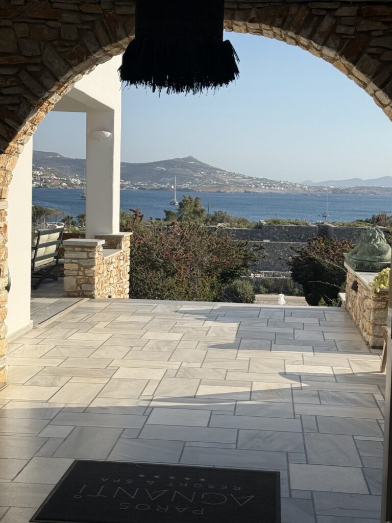Arched stone entrance with a view over Parikia bay at Paros Agnanti