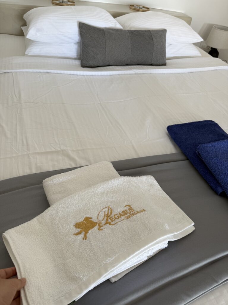 Pegasus Suites and Spa branded towels on bed