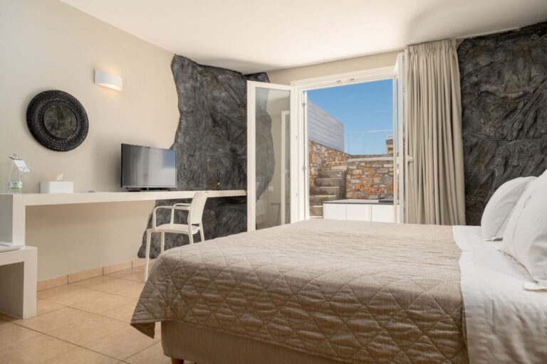 Bedroom opening onto the private terrace at Paros Agnanti Cave Suite