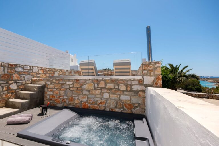 Private outdoor jacuzzi with sea views at Paros Agnanti Cave Suite