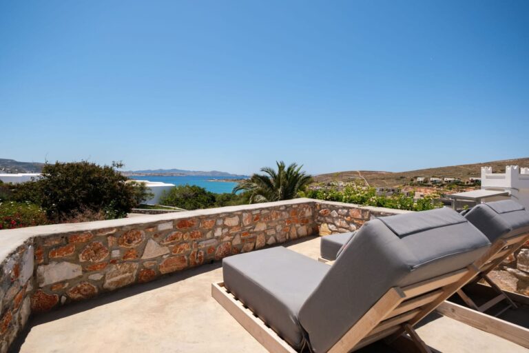 Sun loungers overlooking the sea on the private terrace at Paros Agnanti