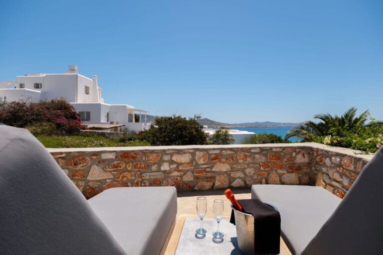 Private terrace with sun loungers and champagne overlooking the bay at Paros Agnanti