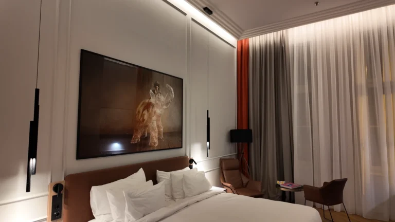 Elegant hotel bedroom with king bed and comfortable seating at Radisson Collection Budapest