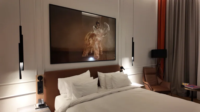 King-size bed with modern wall art at Radisson Collection Basilica Budapest