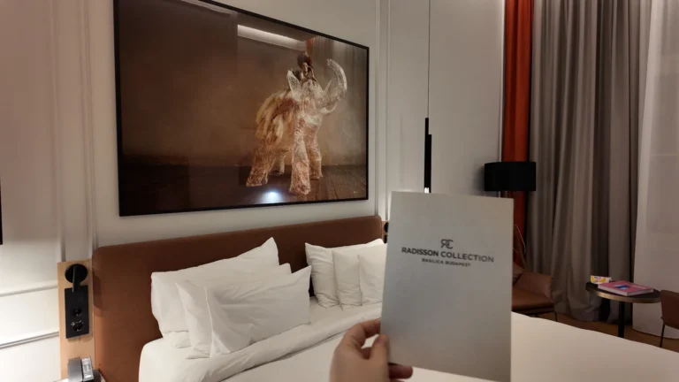 Welcome card and hotel room interior at Radisson Collection Basilica Budapest