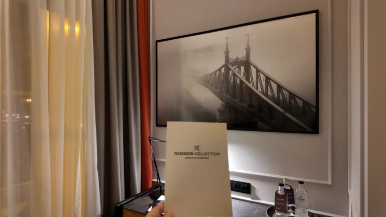 Hotel room artwork and complimentary bottled water at Radisson Collection Basilica Budapest
